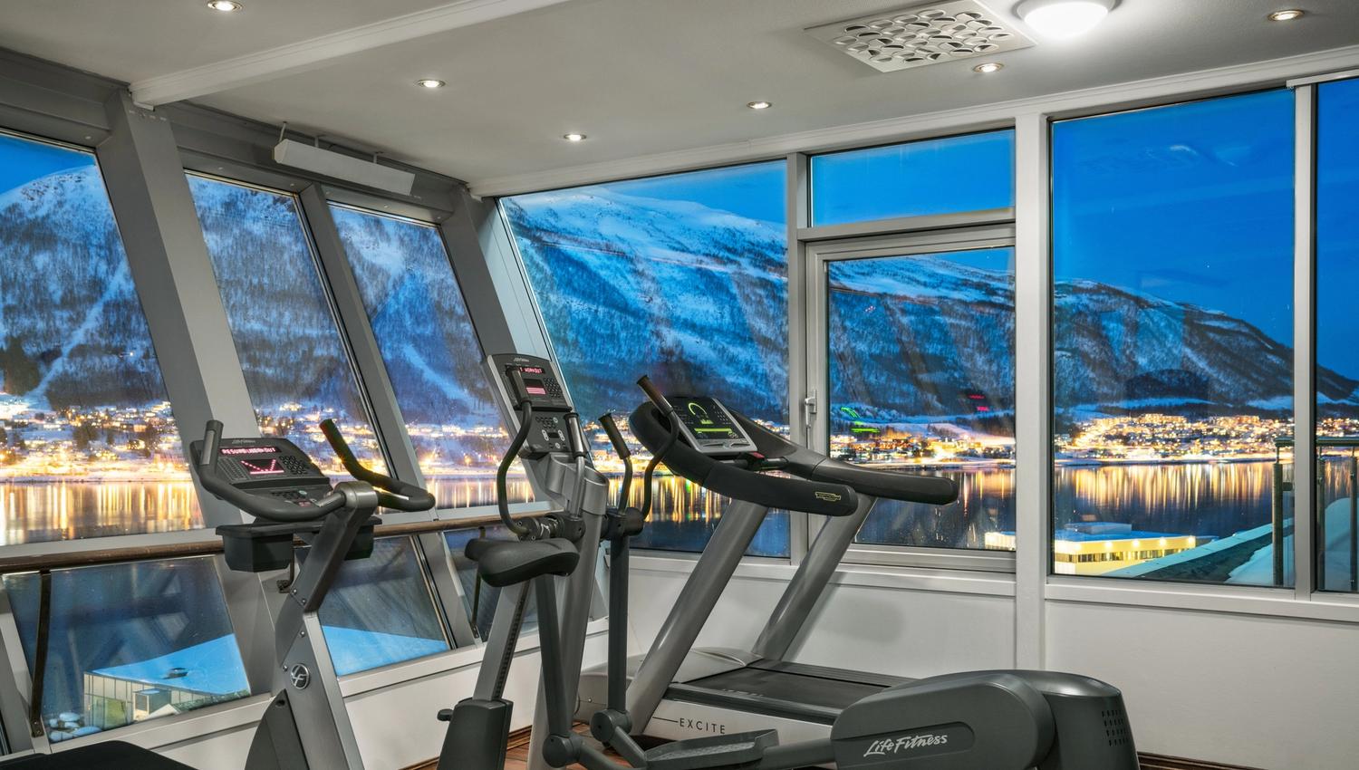a gym with treadmils and an amazing view