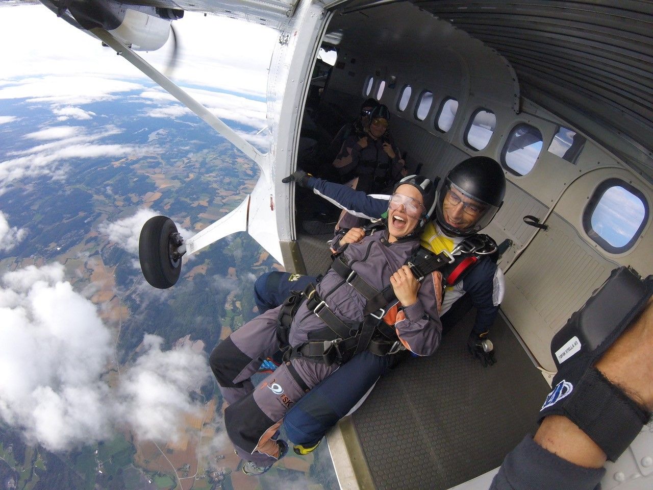 Two people about to jump out of the plane in the air
