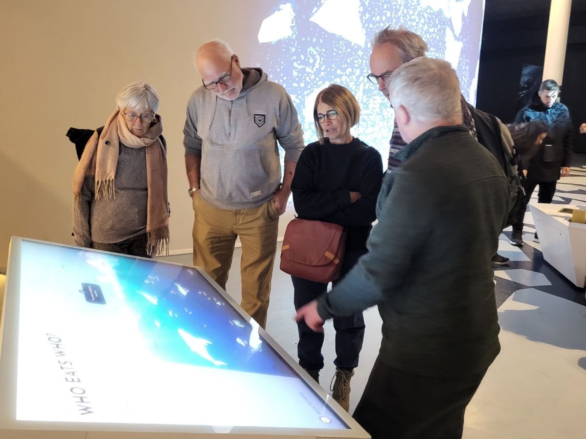 Guests engaged with one of the screens in the museum exhibition