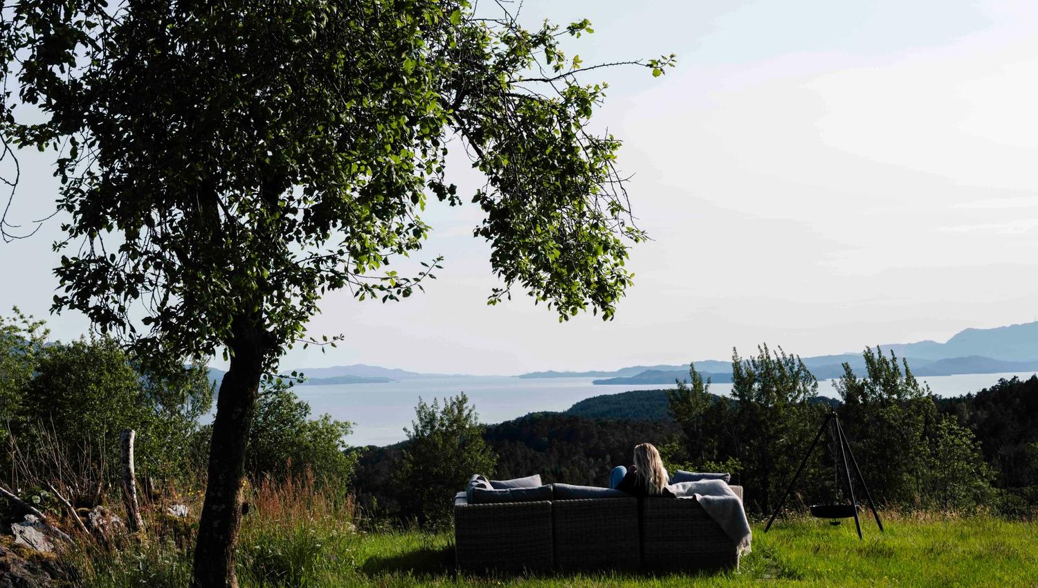 Enjoying the fjord view from the outdoor lounge at Stigen Fjordlodge in Hardanger.