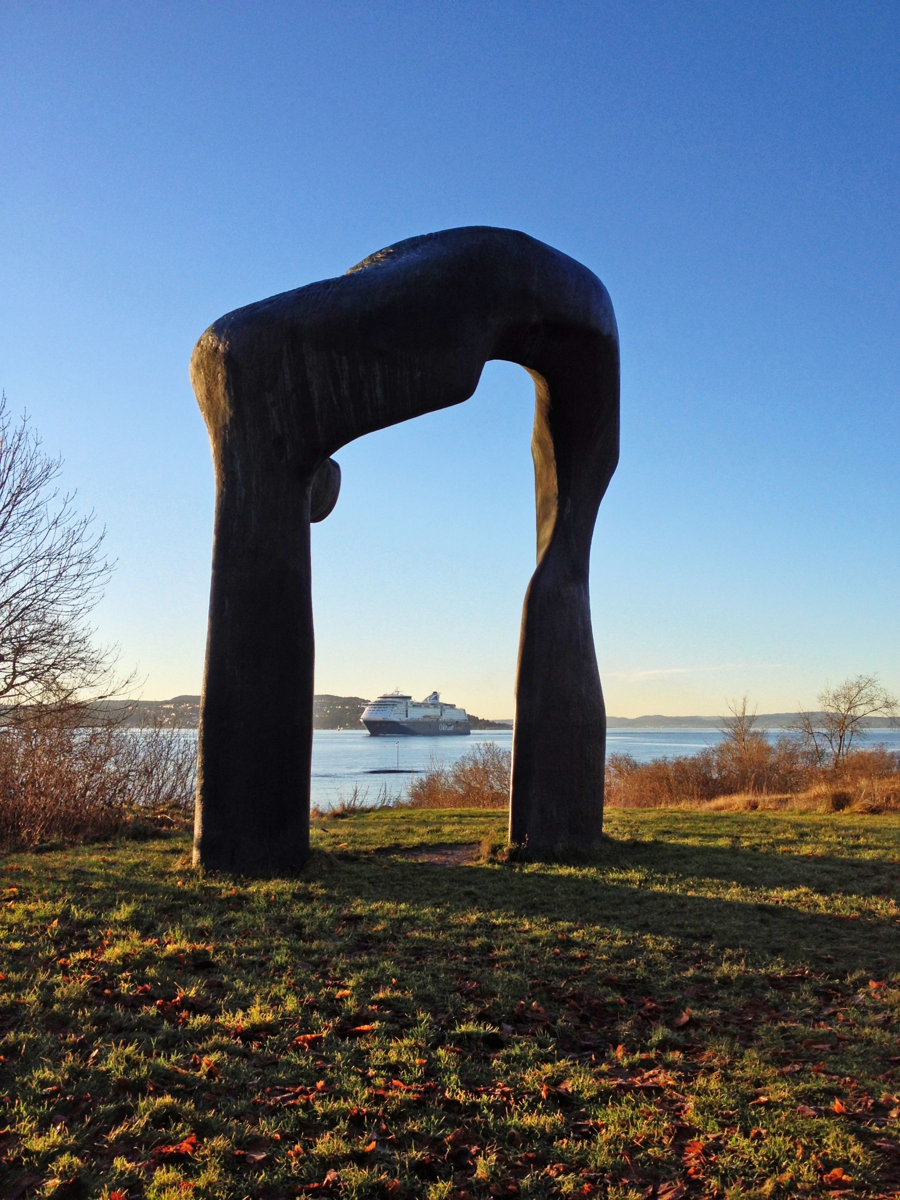 Stone sculpture with the fjord in the background.