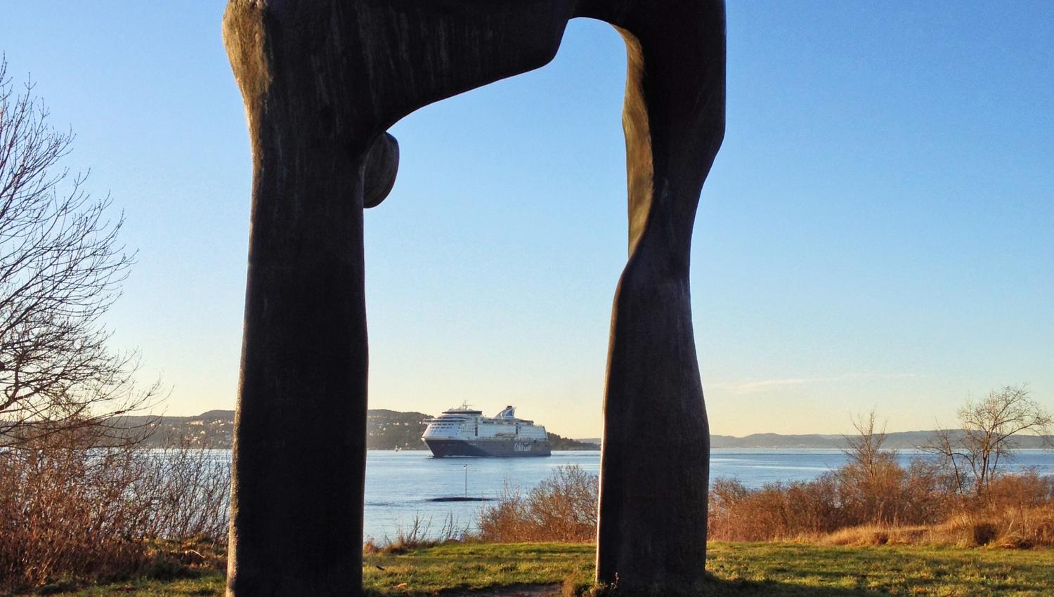 Stone sculpture with the fjord in the background.