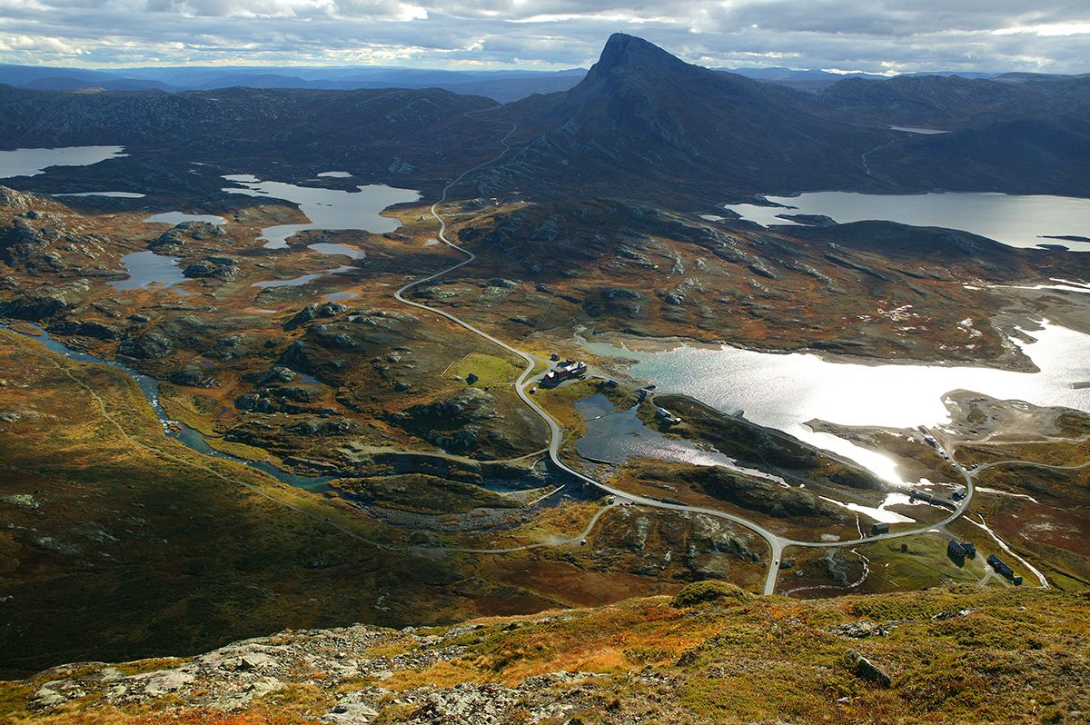 Breathtaking view from Synshorn towards Bygdin, Bitihorn and many small lakes. The National Tourist Route Valdresflye winds through the rugged mountai