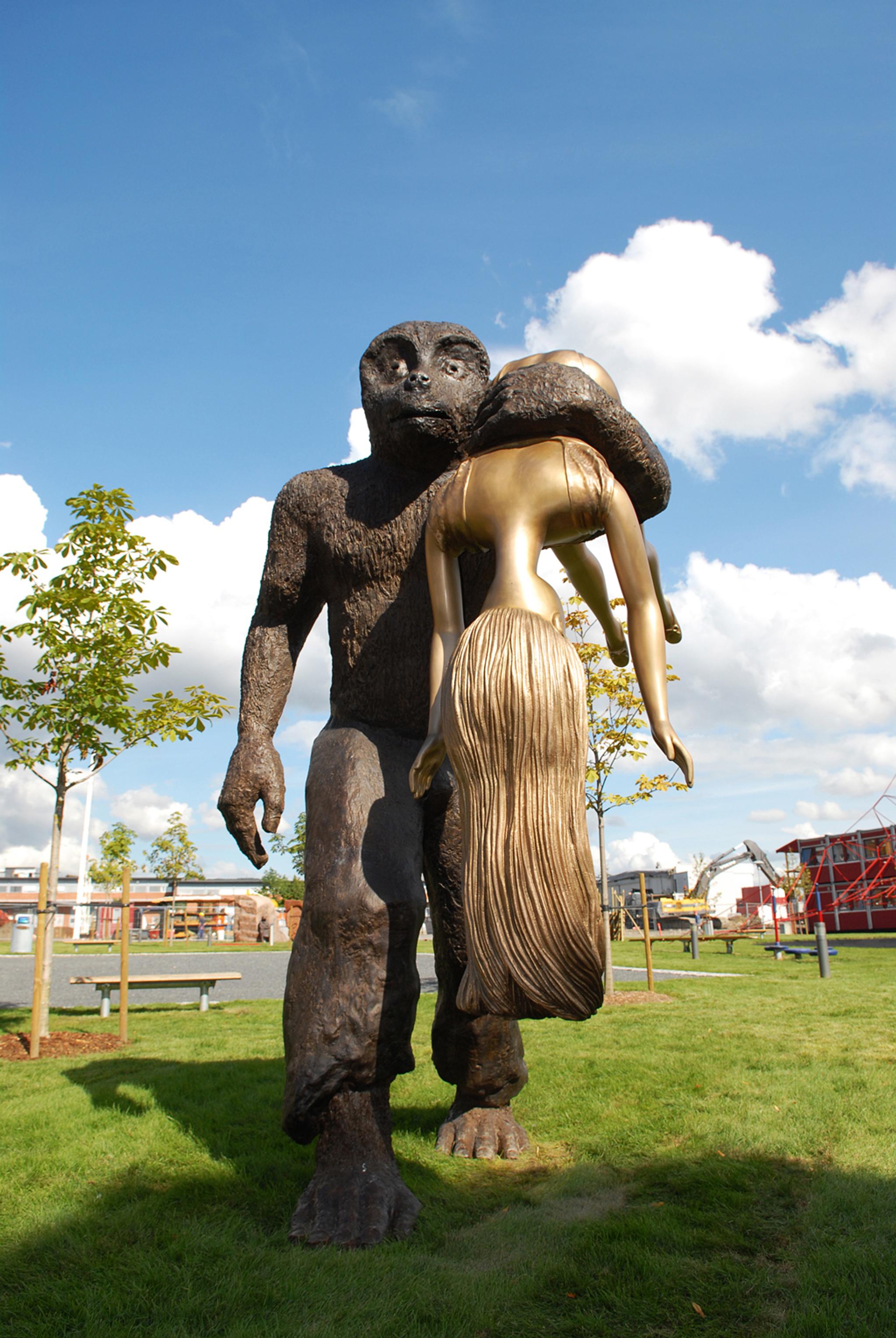 statue of a troll carrying a woman 