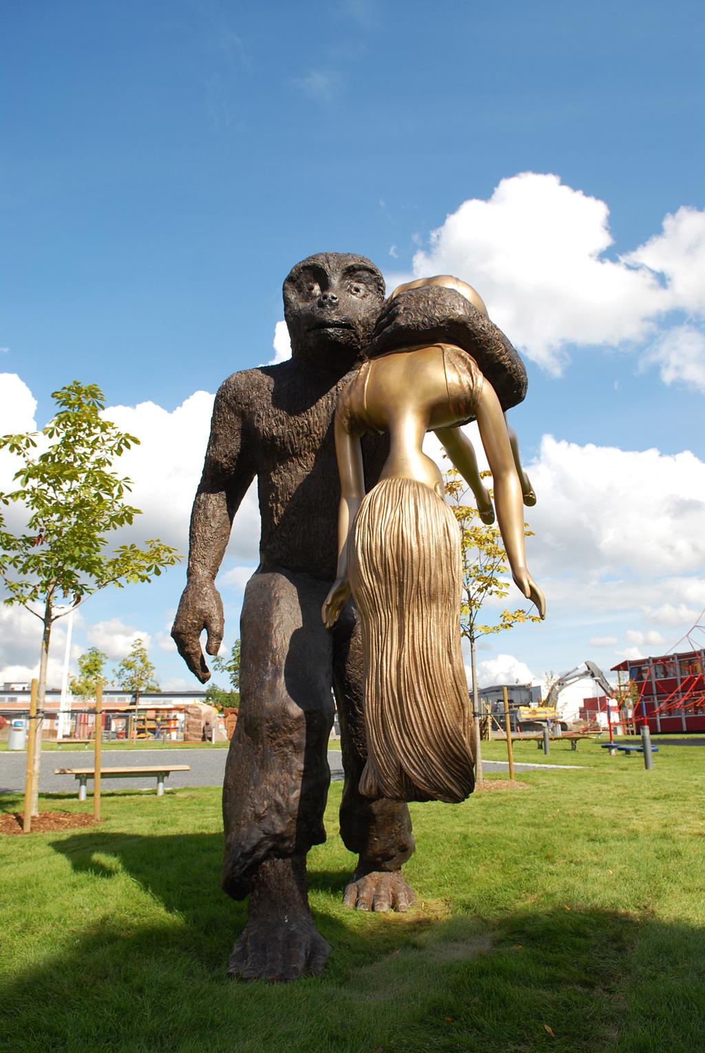 statue of a troll carrying a woman