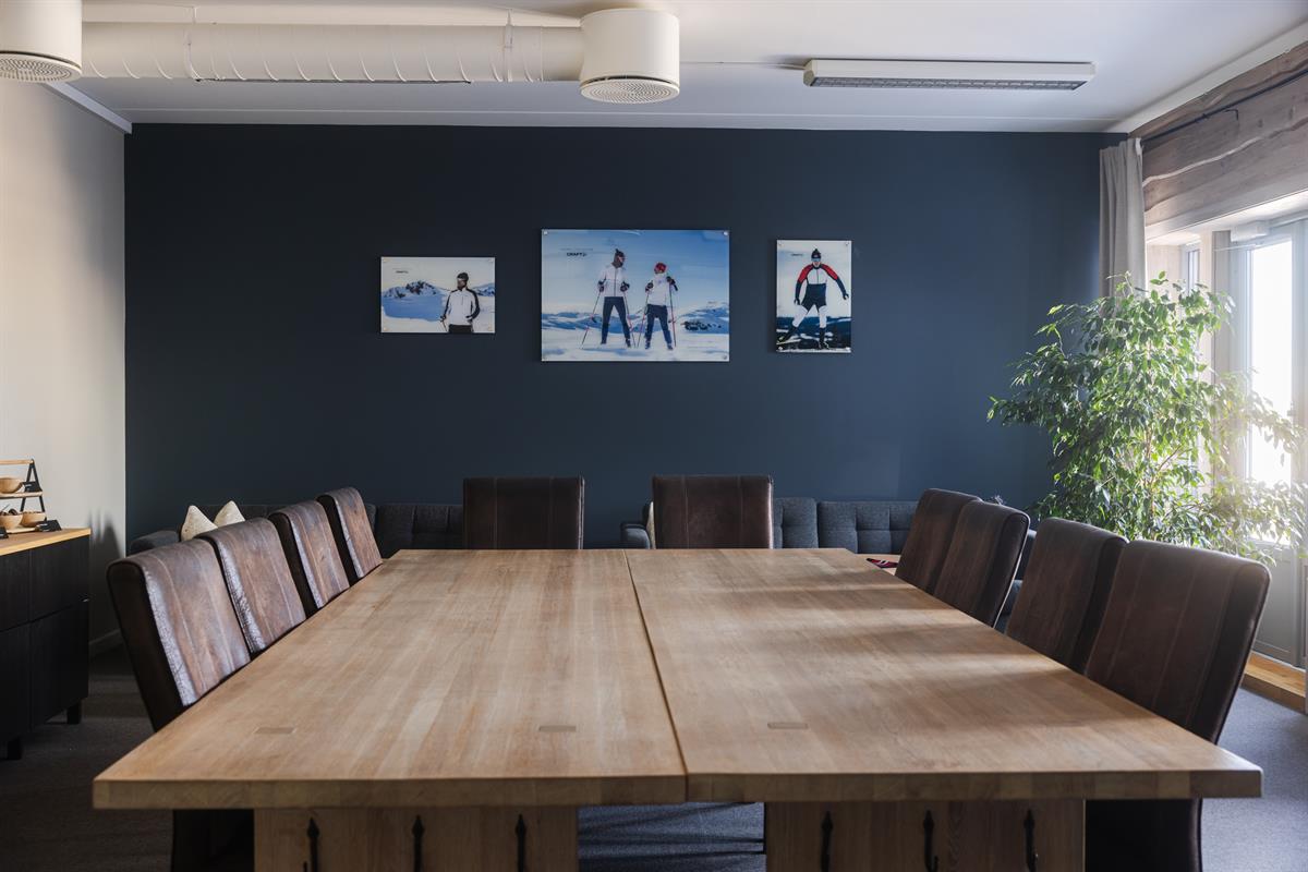 Modern meeting room with large conference table and seating.