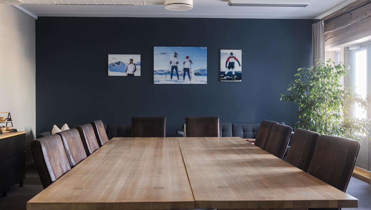 Modern meeting room with large conference table and seating.