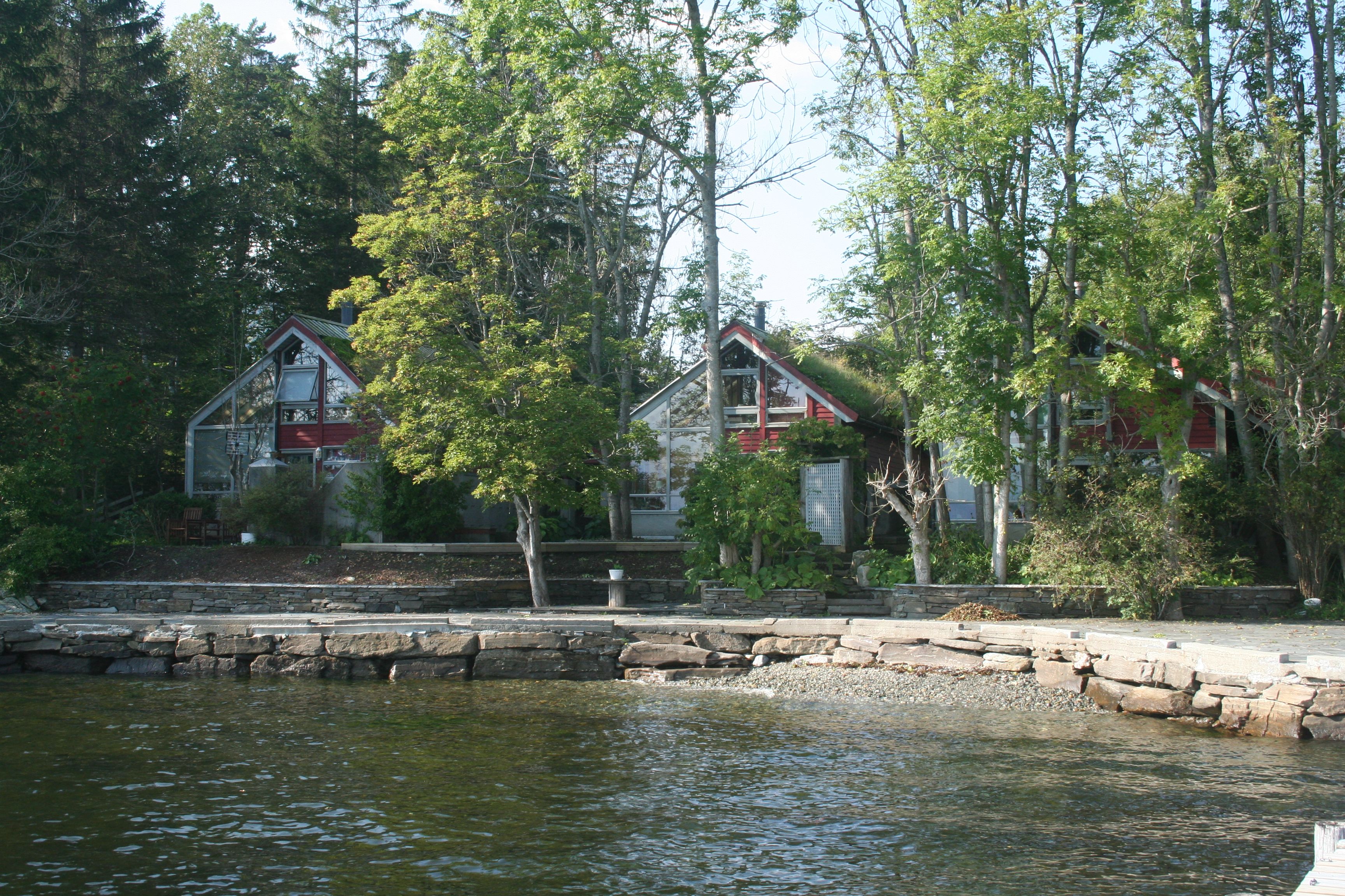 Charming cabins nestled among trees by the waterfront at Hardanger Feriesenter.