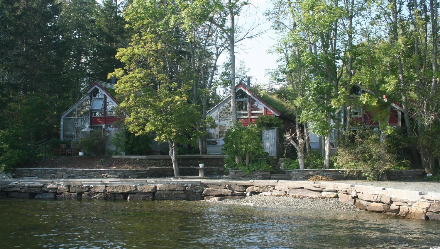Charming cabins nestled among trees by the waterfront at Hardanger Feriesenter.