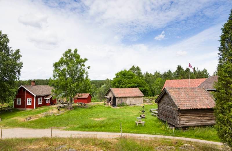 an old farm with a red main building 