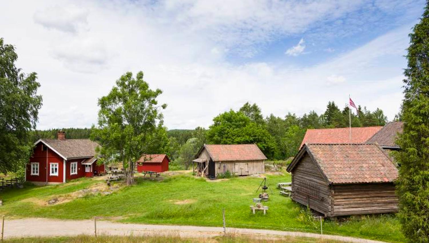 an old farm with a red main building