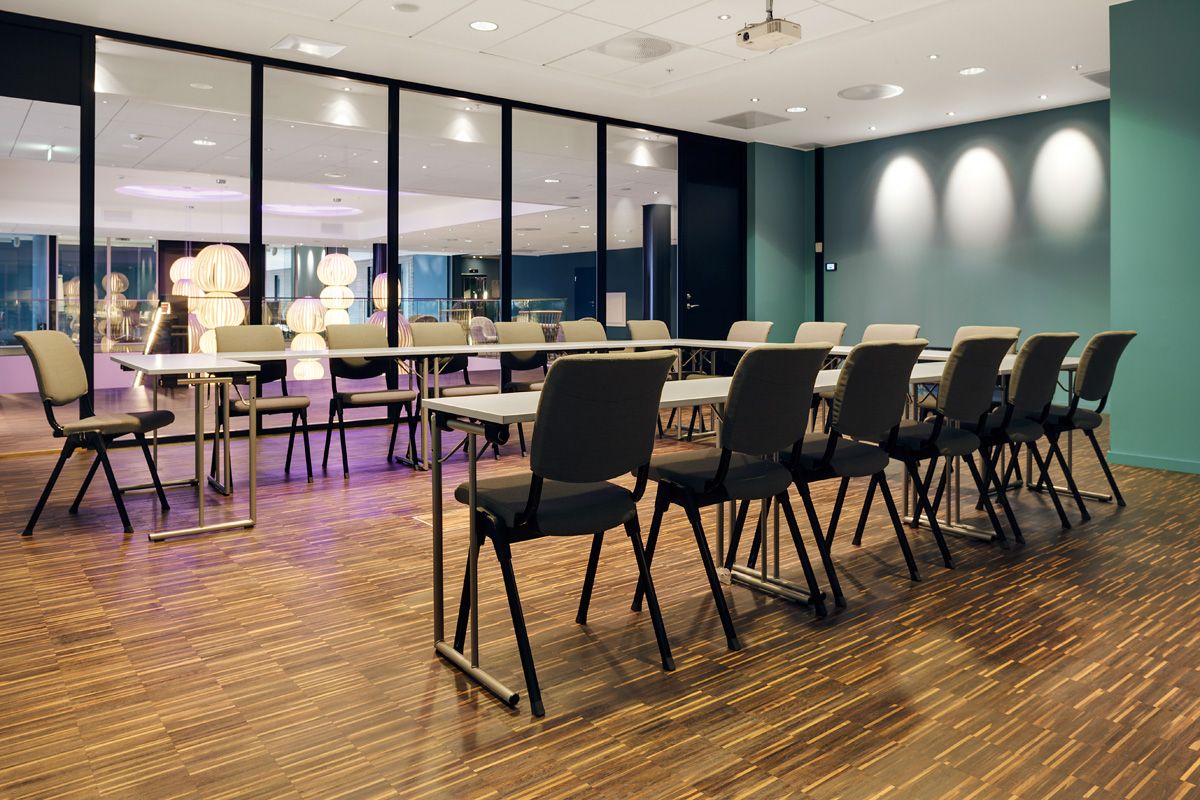 conference hall with horseshoe-shaped tables and conference technology