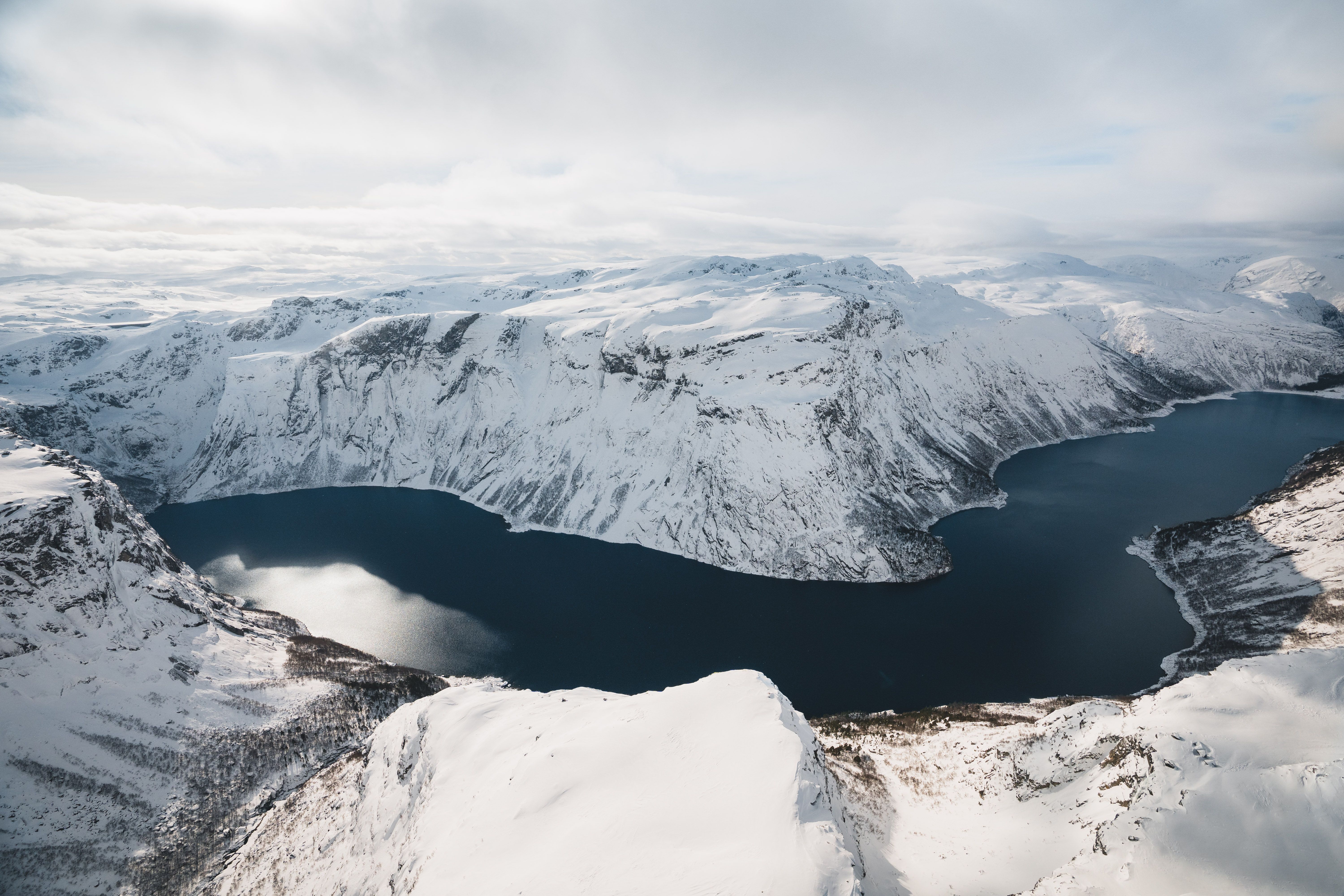 A overview of the Hardangerfjord surrounded by snow-covered mountains. 