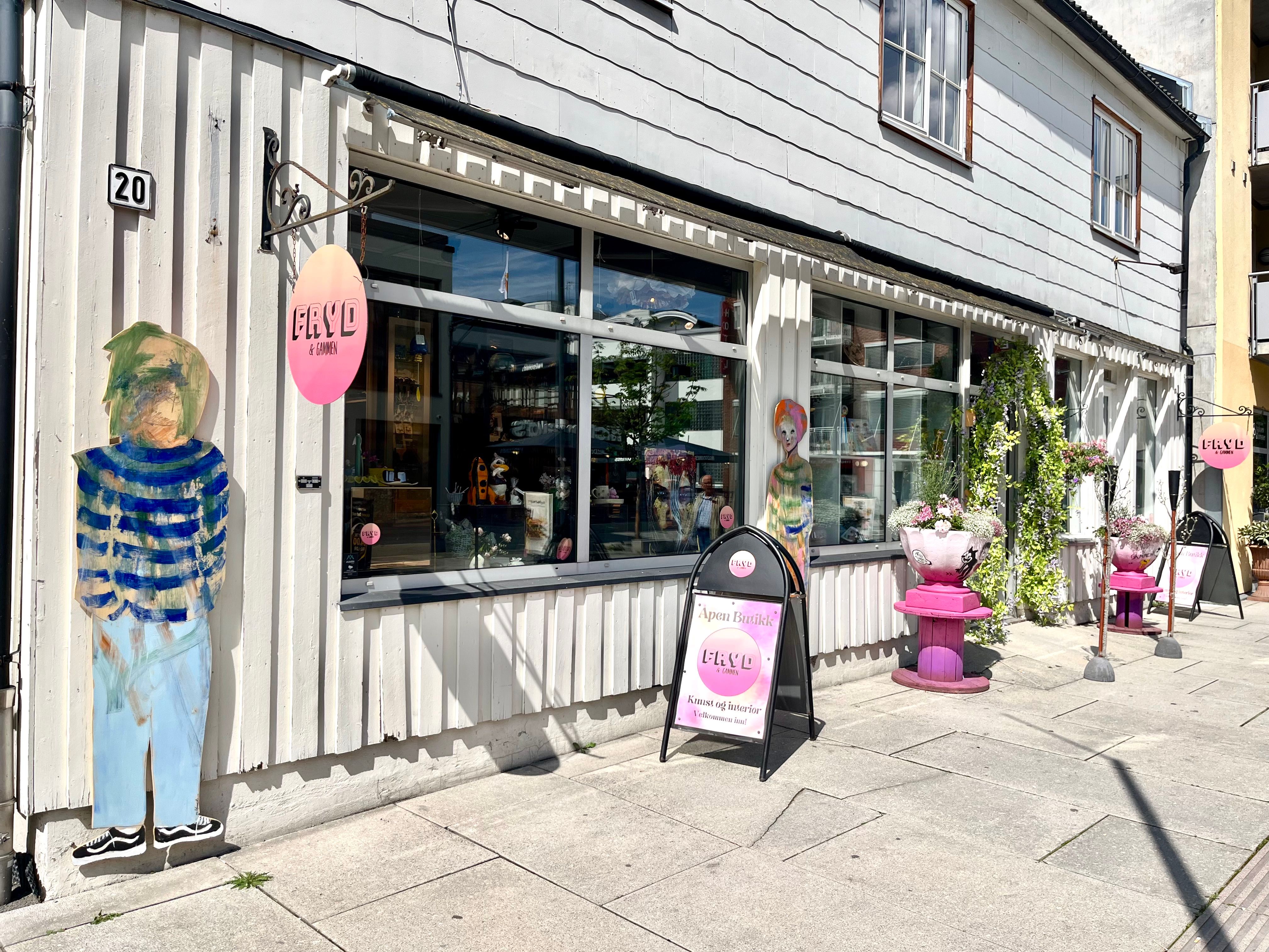 Shop with a display outside a grey house