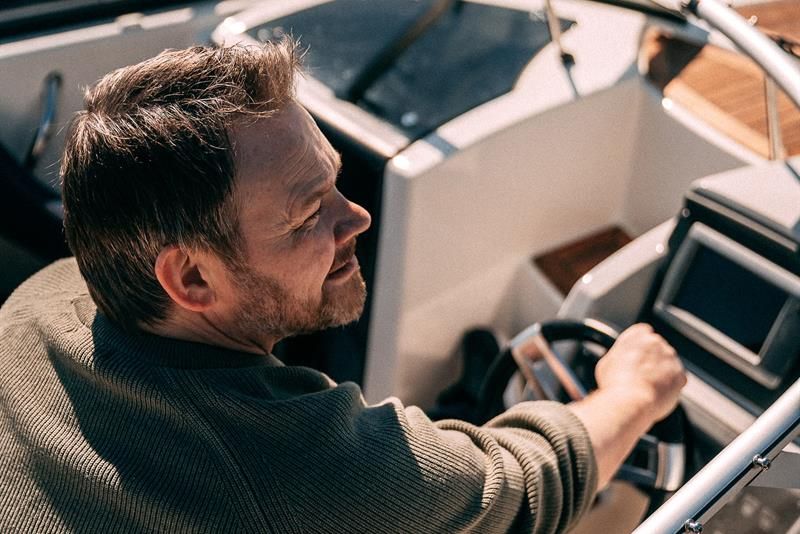 A man driving a motorboat