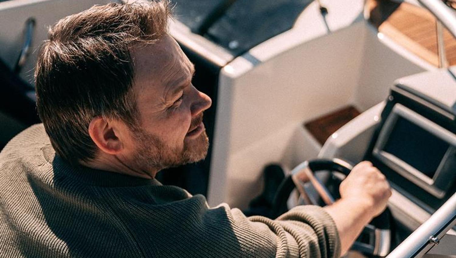 A man driving a motorboat