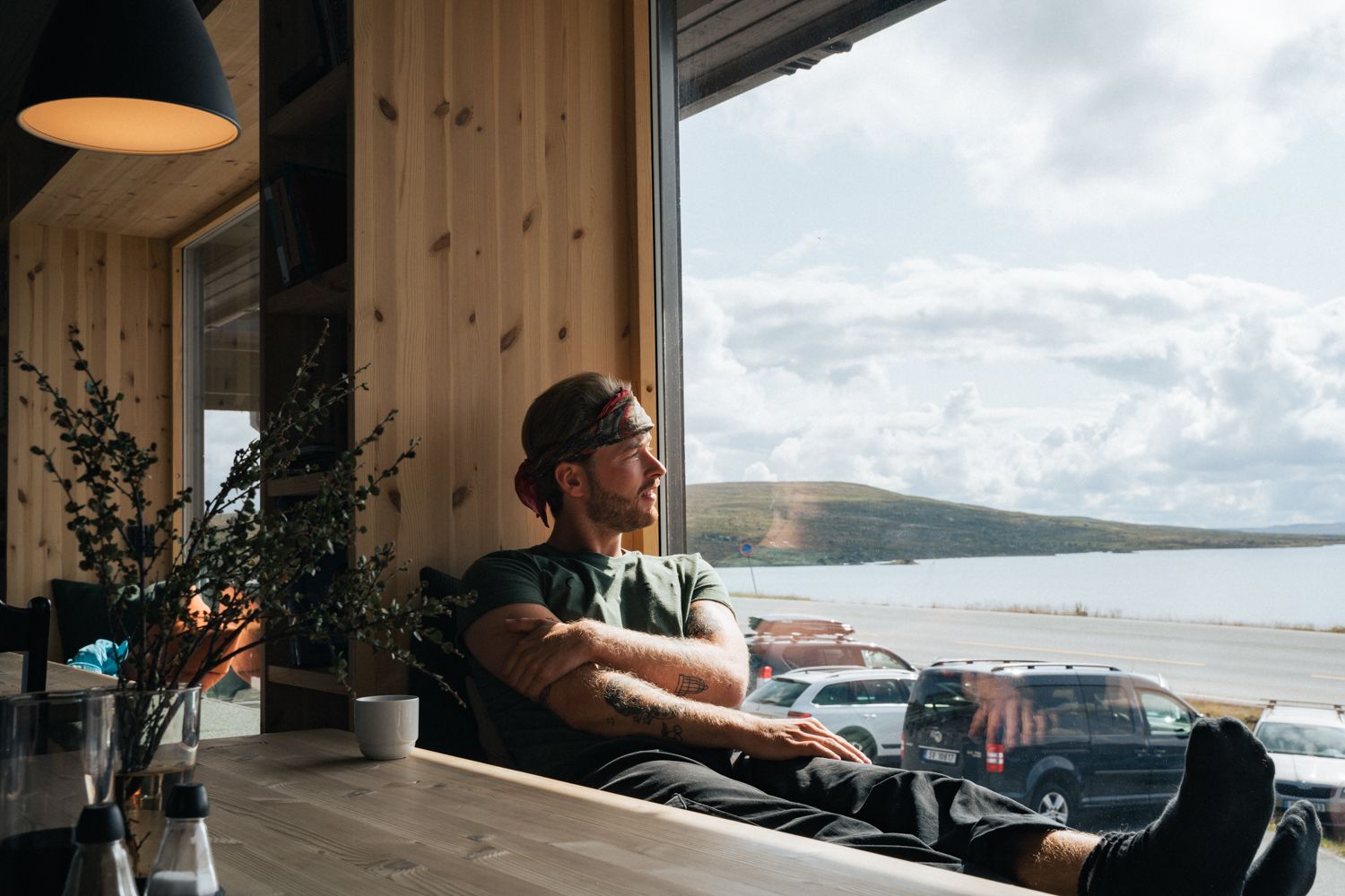 A man relaxing by the window in the restaurant.