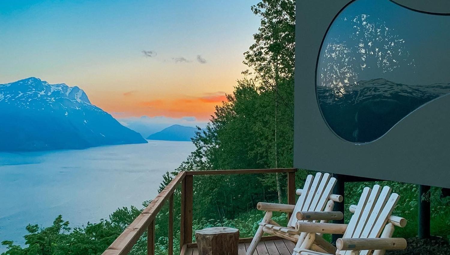 Stunning panoramic view from the Birdbox cabin at Skaara Living on Lotsberg in Nordfjord, surrounded by mountains and fjord landscape.