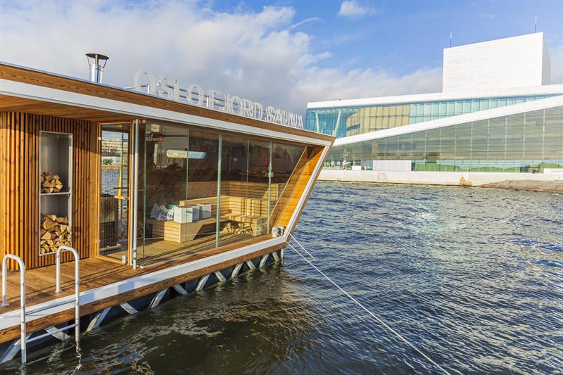 one of the sauna rafts on the water with the Opera House in the background