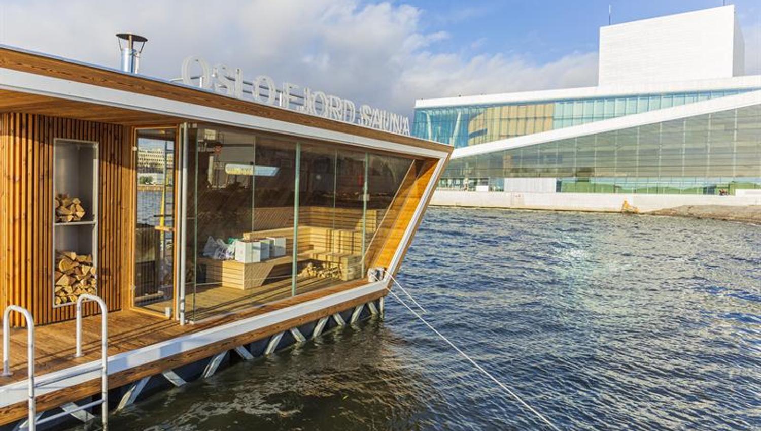 one of the sauna rafts on the water with the Opera House in the background