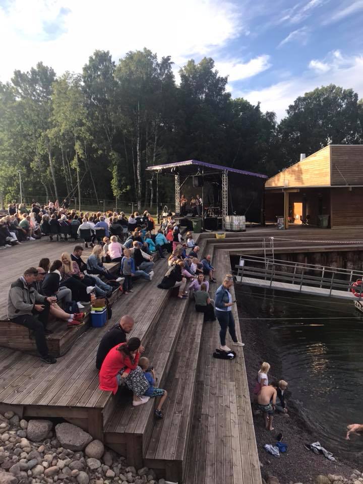 People sit by the water