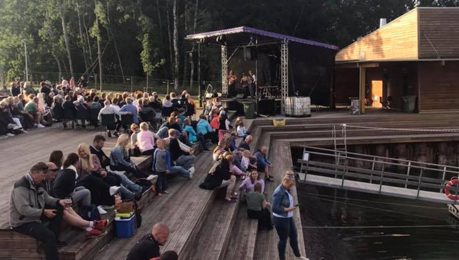 People sit by the water