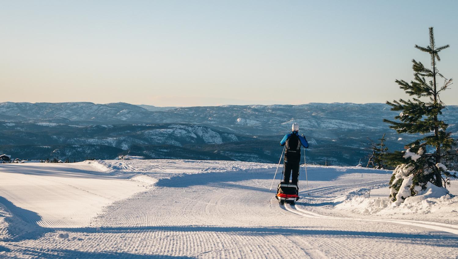 man with sledge on cross-country ski on Lifjell