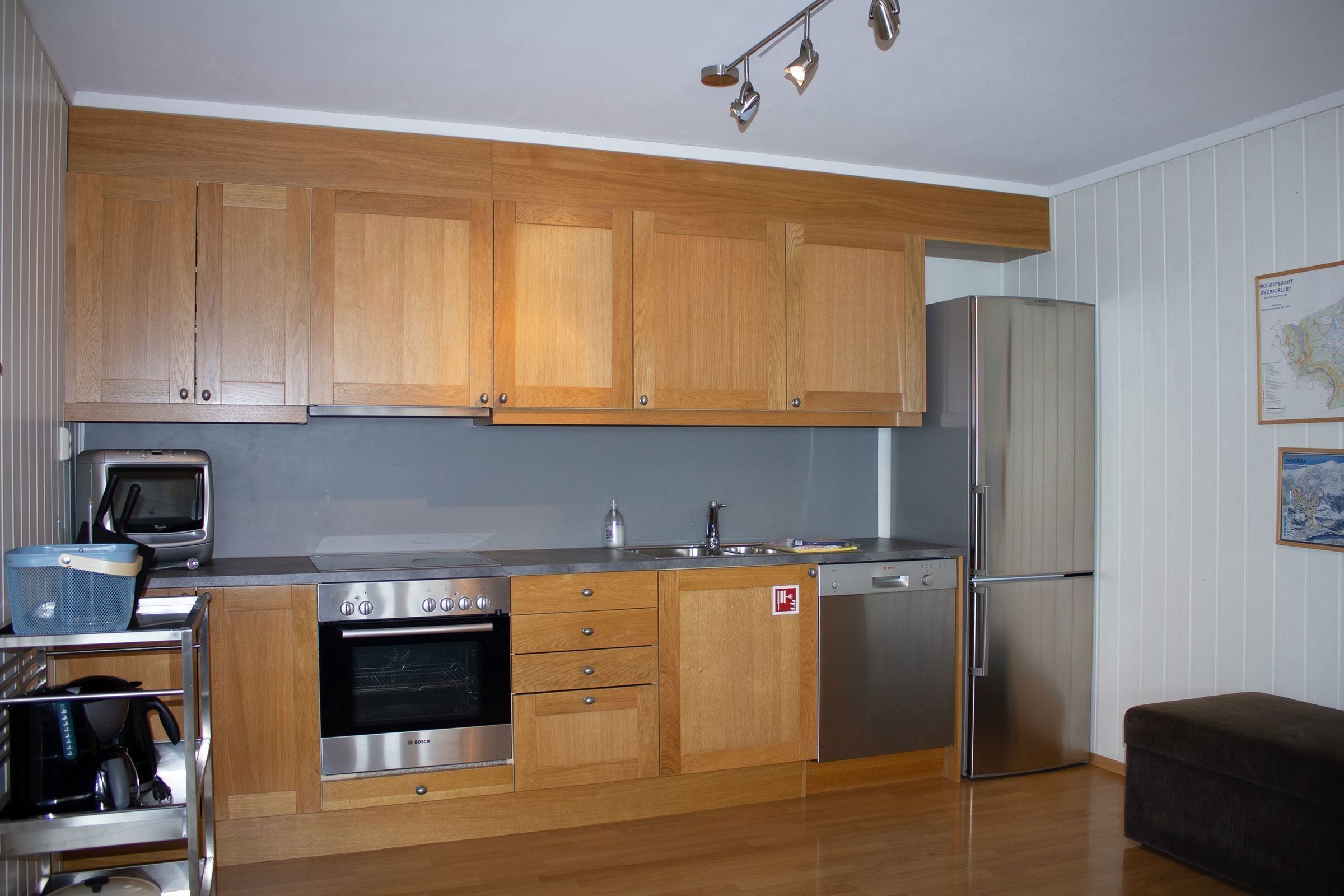 A kitchen with wooden cabinets and stainless steel appliances.