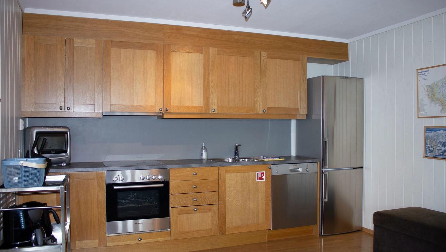 A kitchen with wooden cabinets and stainless steel appliances.