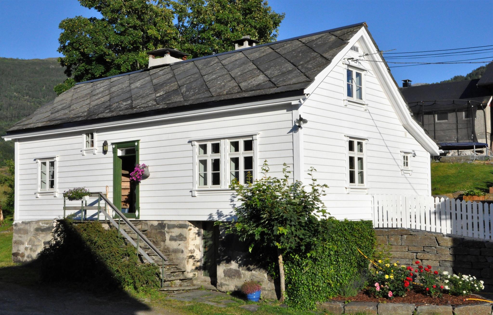 An older wooden house painted white 