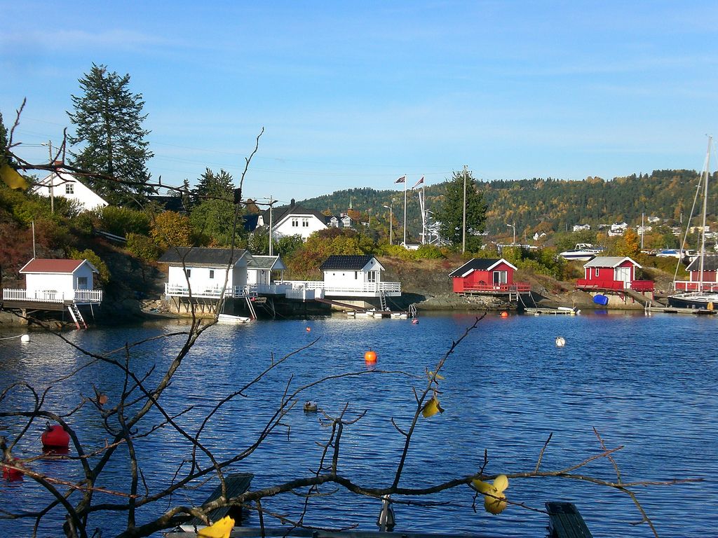waterfront bathhouse, blue sky and fjord