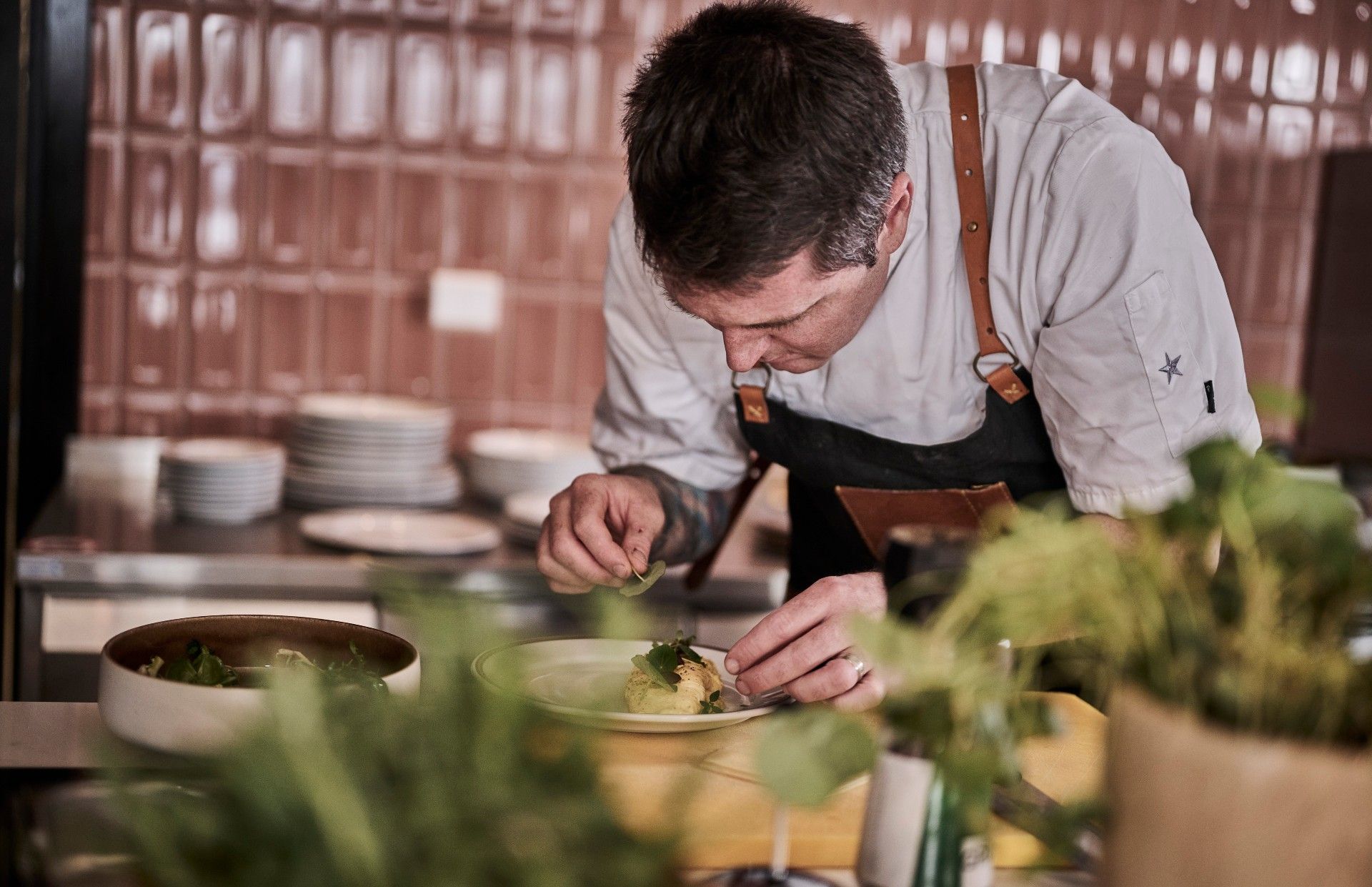 Chef prepares food in the kitchen at Hotell Klubben