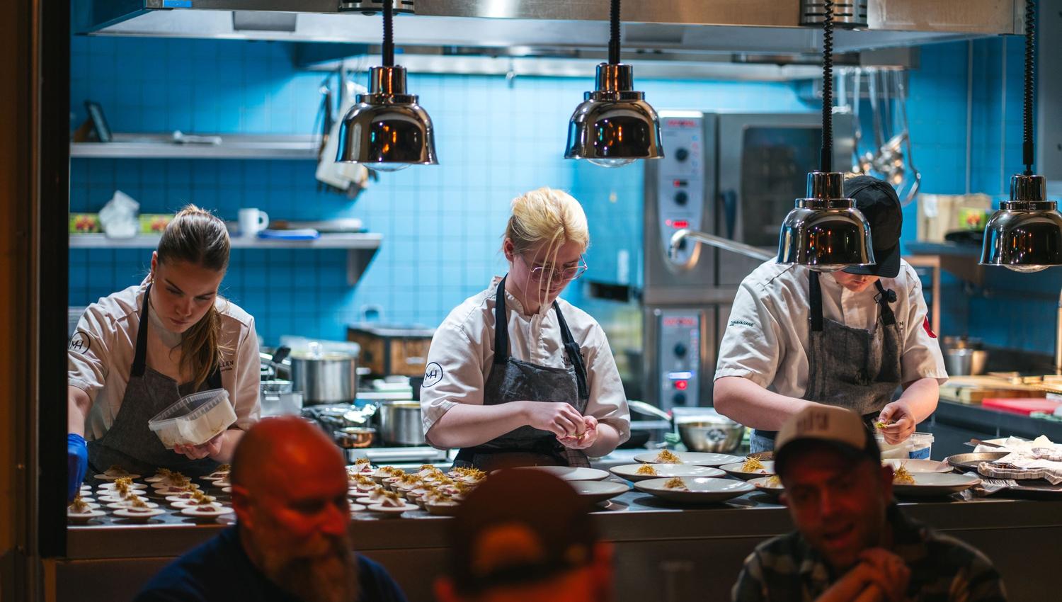 Three people preparing dinner