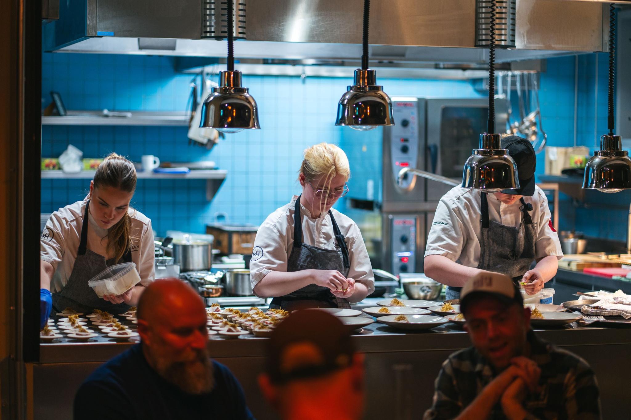 Three people preparing dinner
