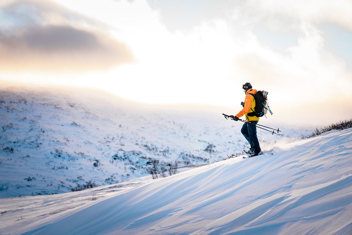 Solo trekker on snowshoes across snowy hills in Hardanger.