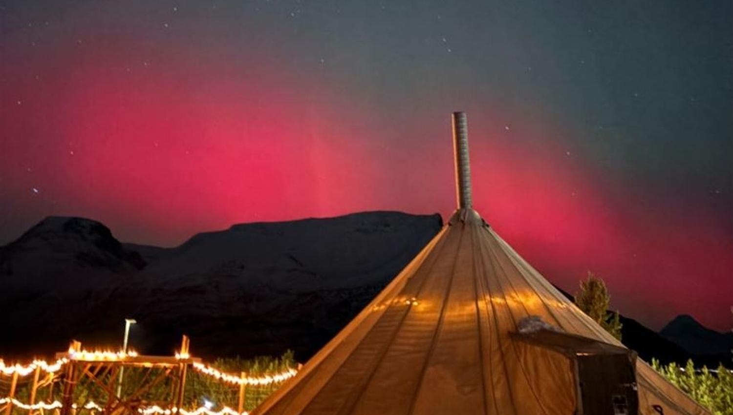 Traditional Sami lavvu under the Northern Lights by Lyngenfjord