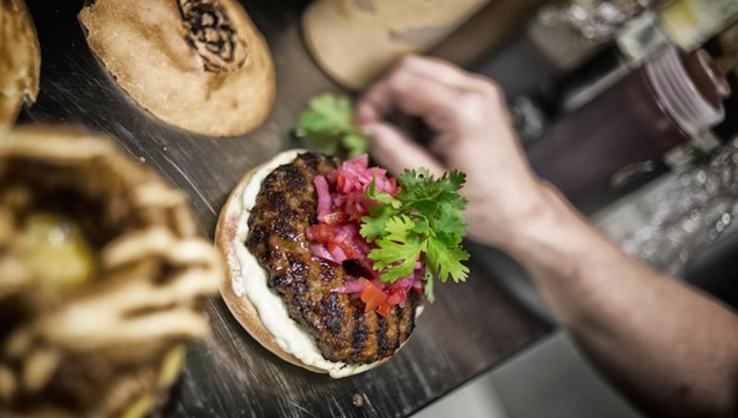 Preparing the burger.