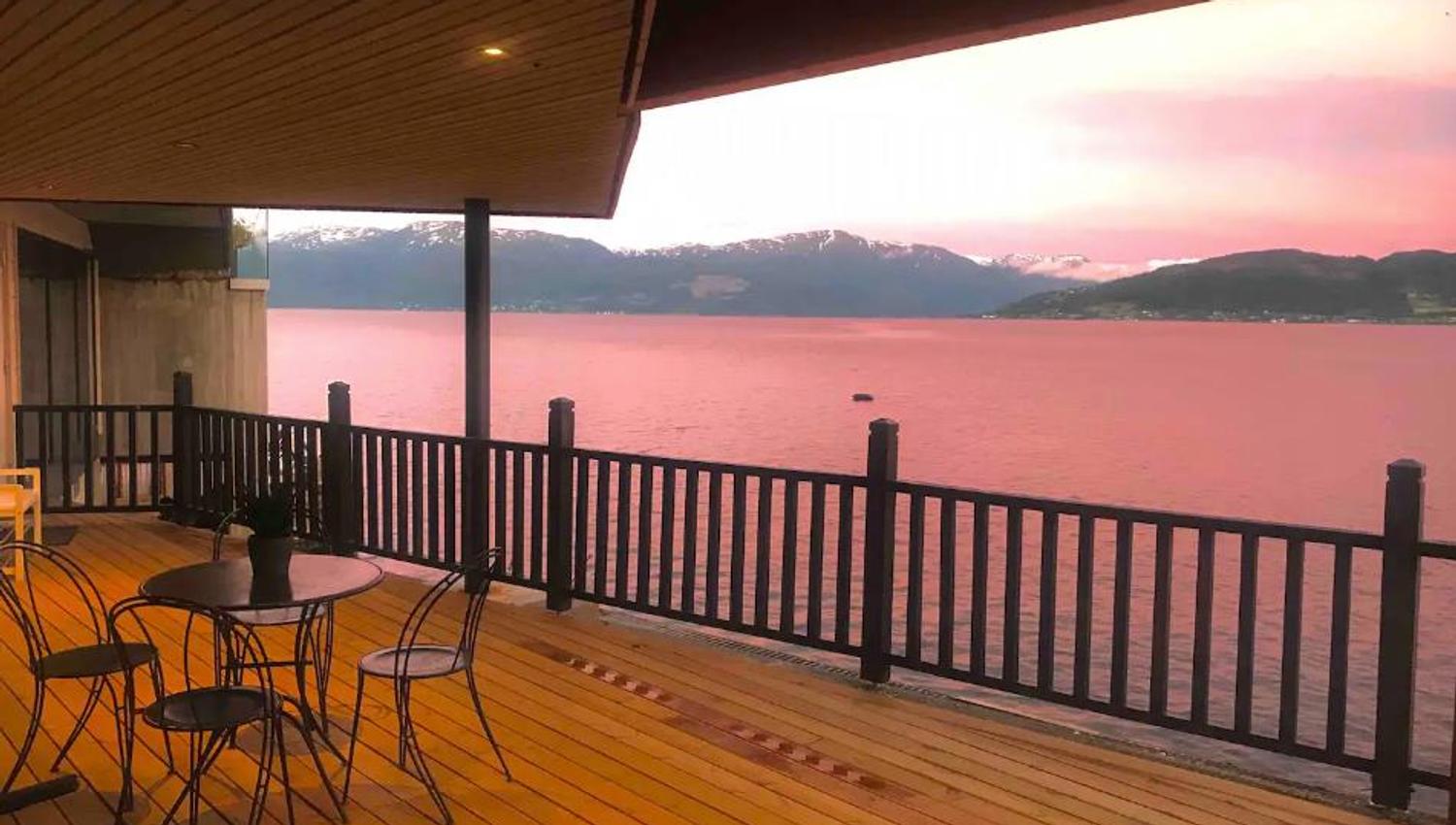 Magical sunset over the Hardangerfjord from a spacious terrace – the perfect place to enjoy the evening.