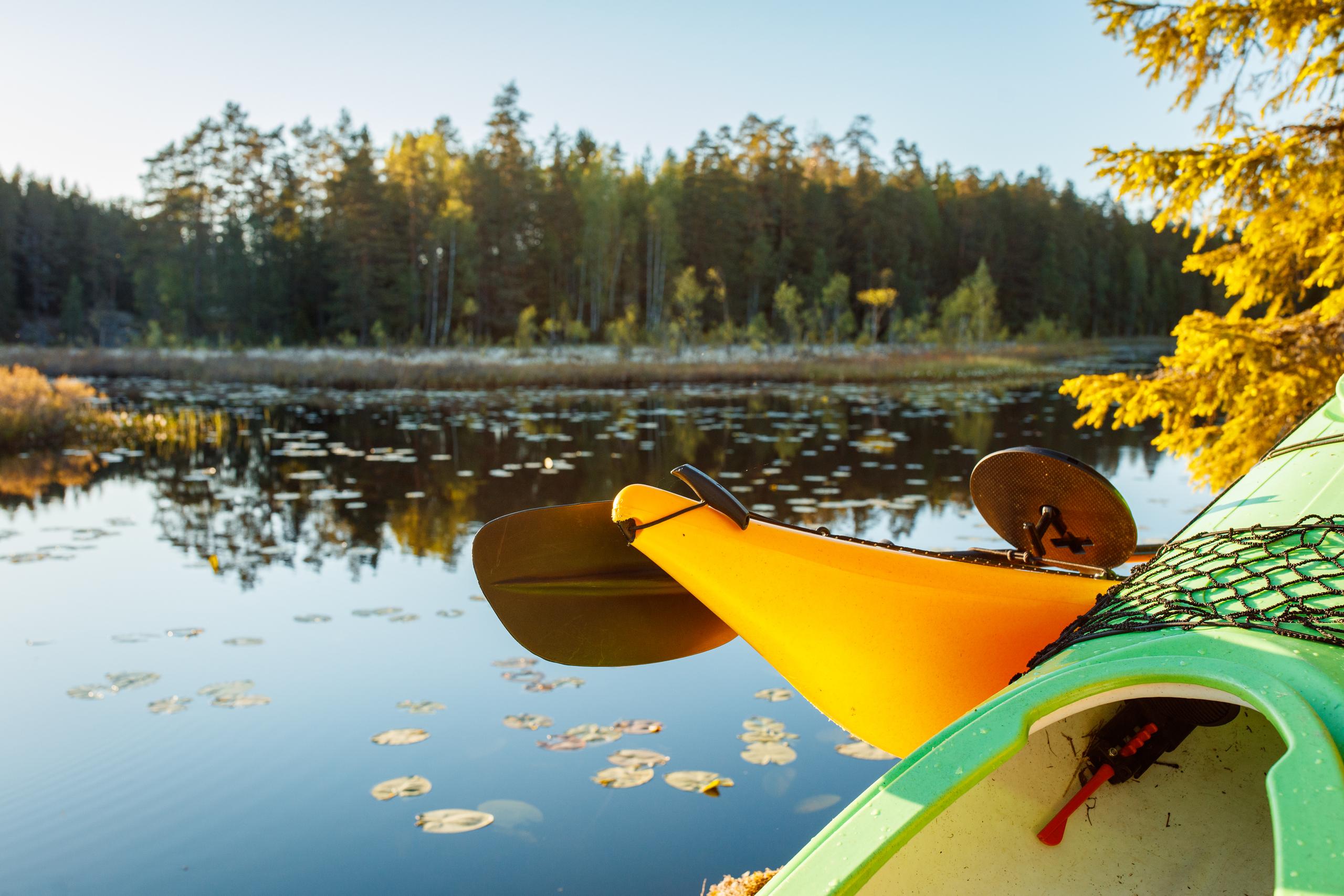 kayak on a lake with autumn colors