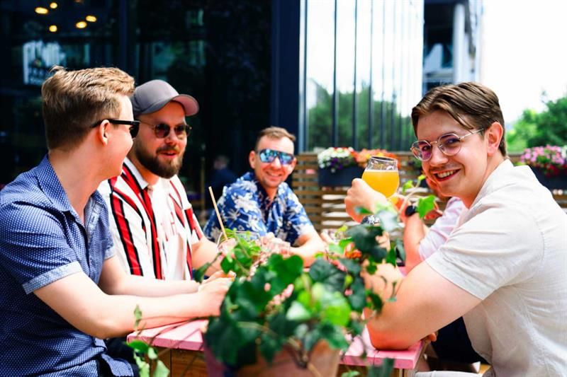 Men drinking by the outdoor terrace