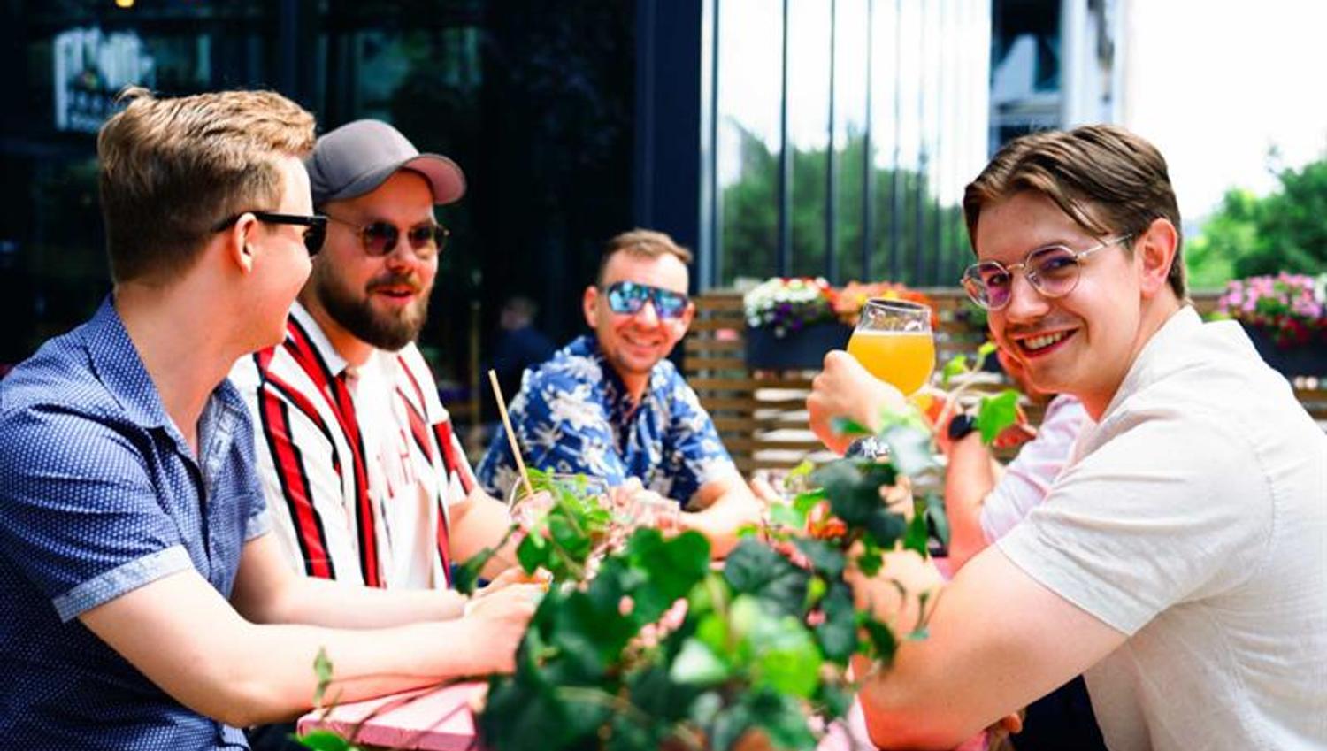 Men drinking by the outdoor terrace