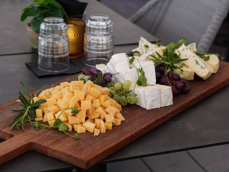 Detail of cheese board and grapes on a table.