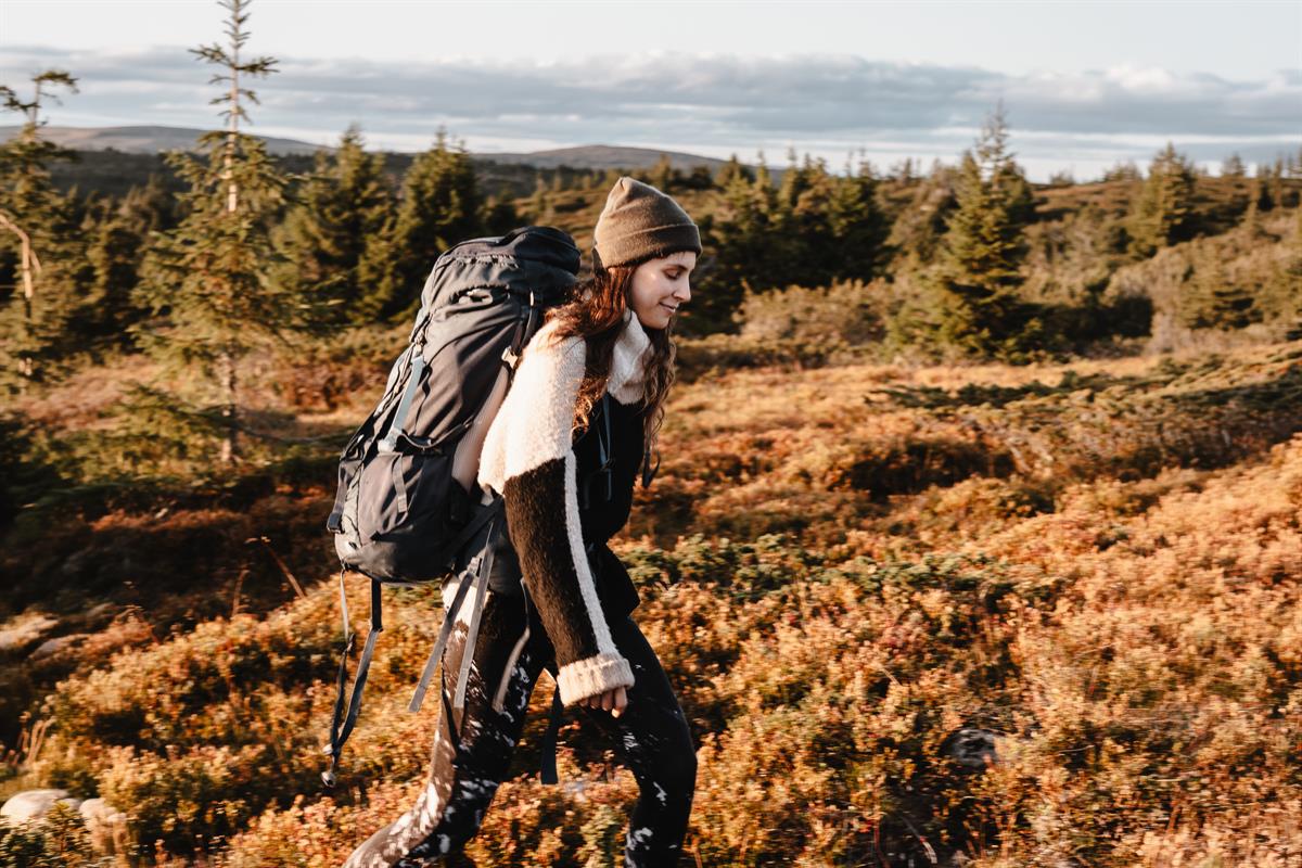 Person with backpack hiking in rugged mountain terrain
