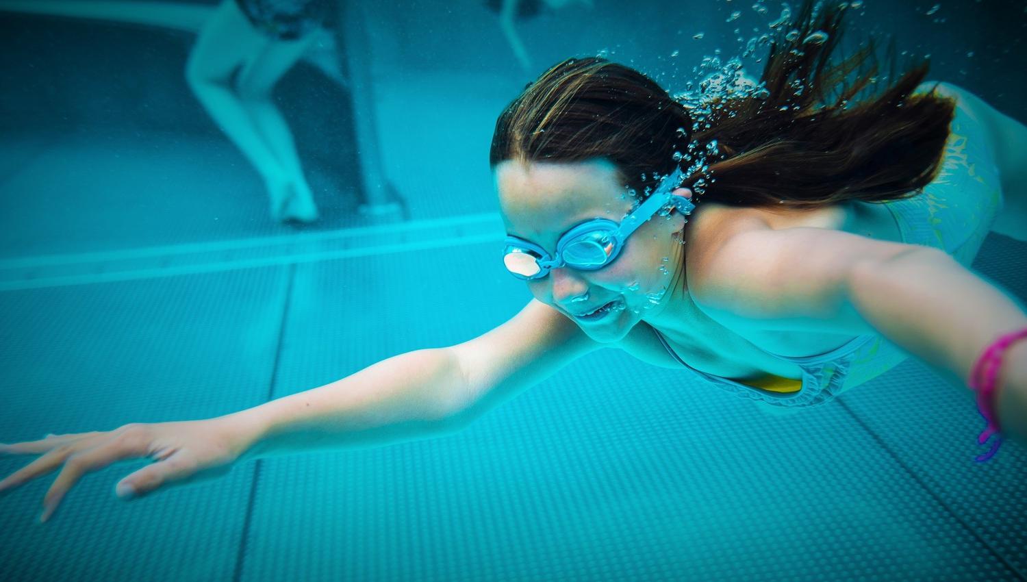 a girl diving under water