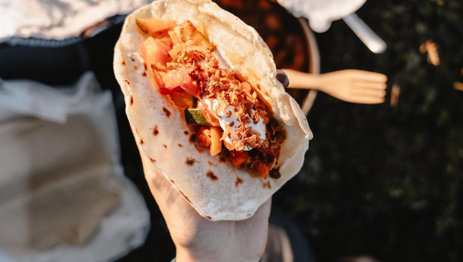 Wrap with meat and vegetables held in hand