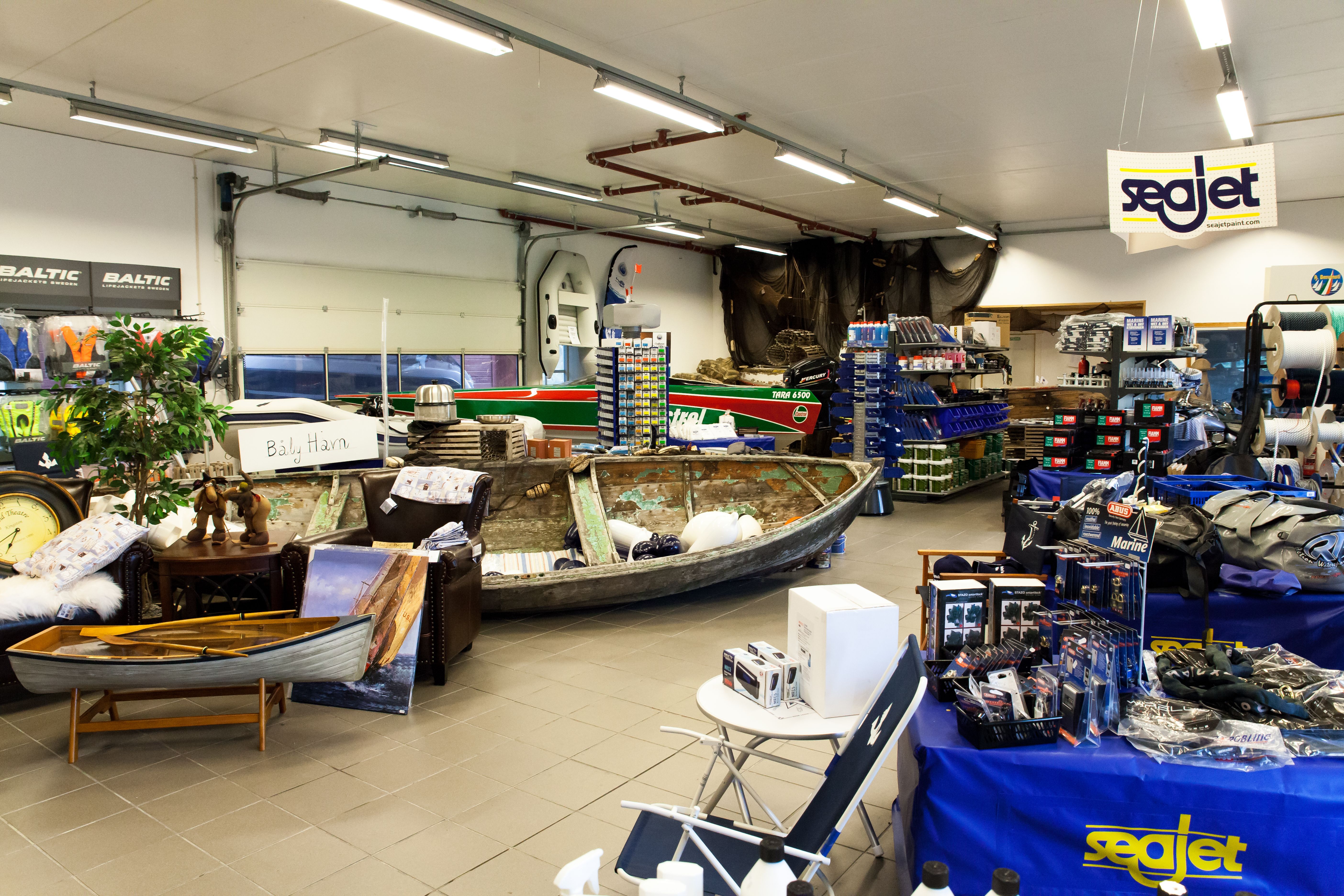 A wide range of boating equipment for sale, including: ropes, life jackets, chairs, sun caps, and bags.