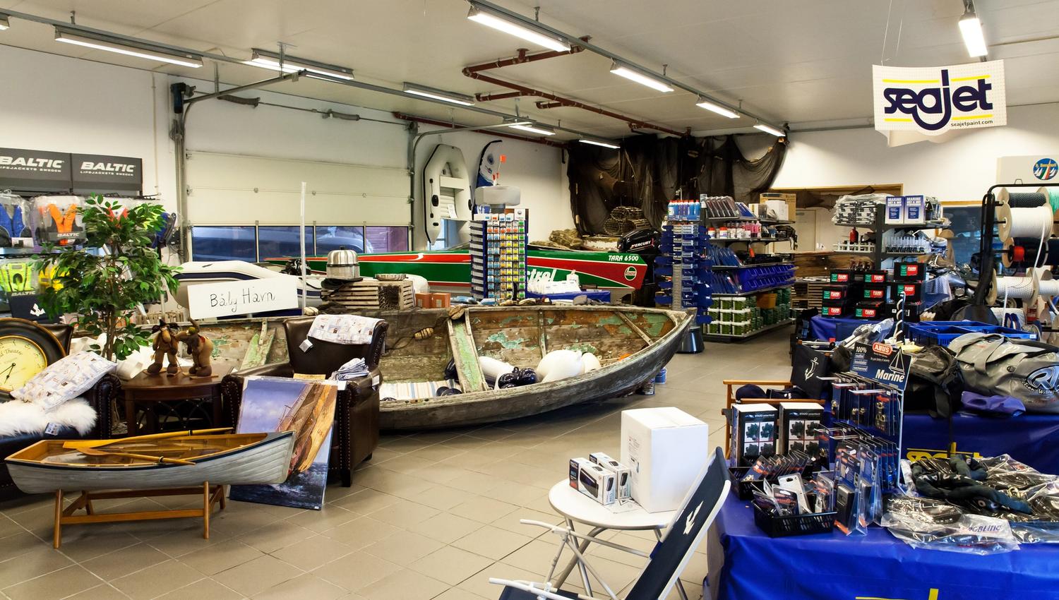 A wide range of boating equipment for sale, including: ropes, life jackets, chairs, sun caps, and bags.