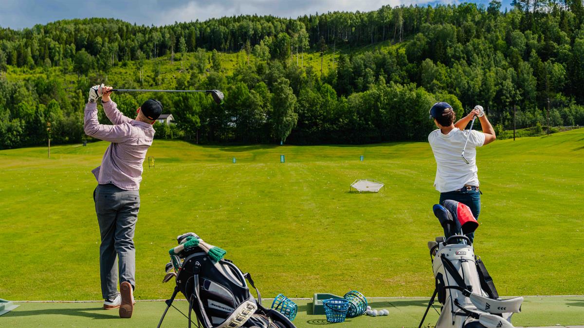 Golfers at a tee area.
