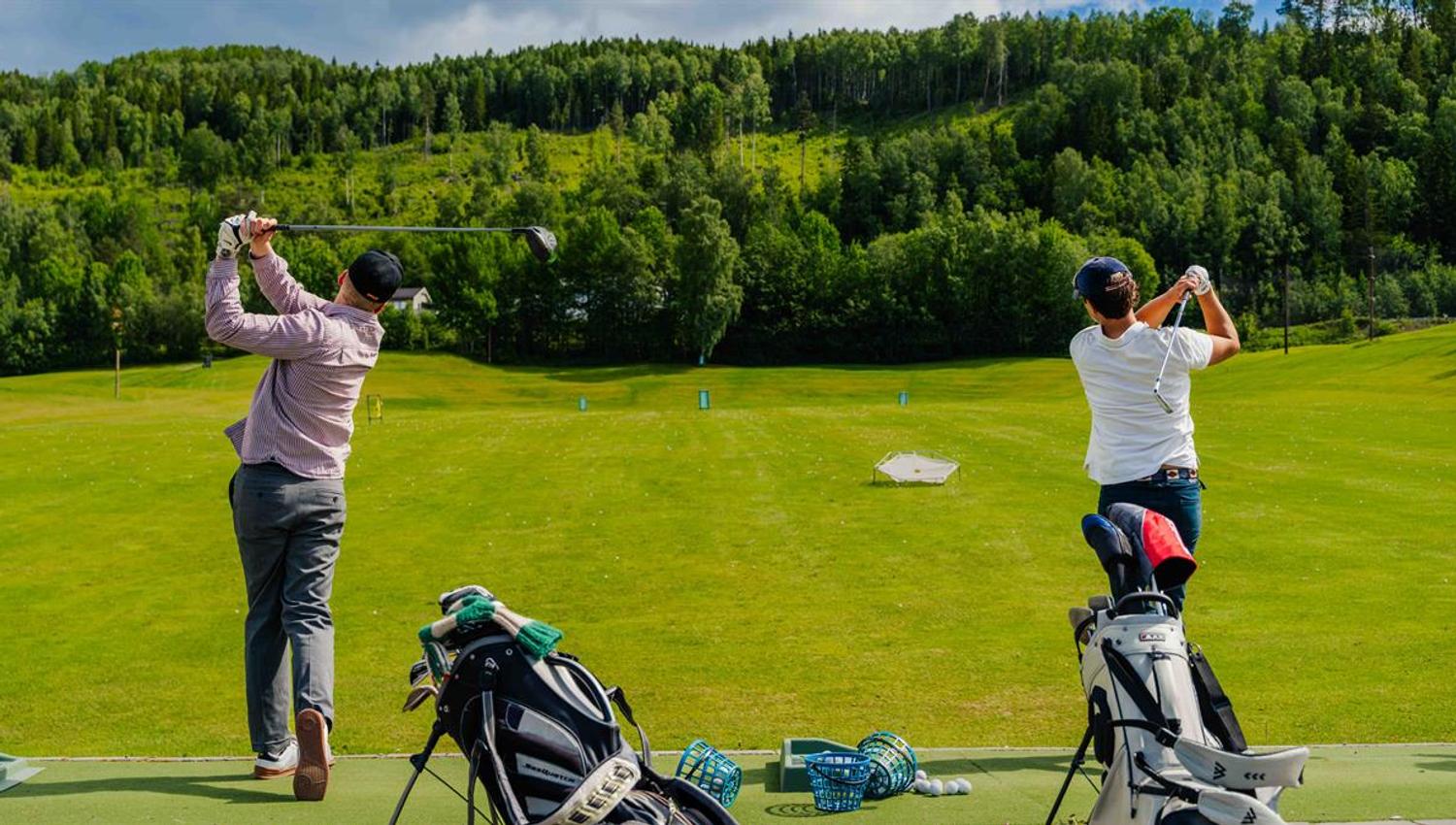 Golfers at a tee area.