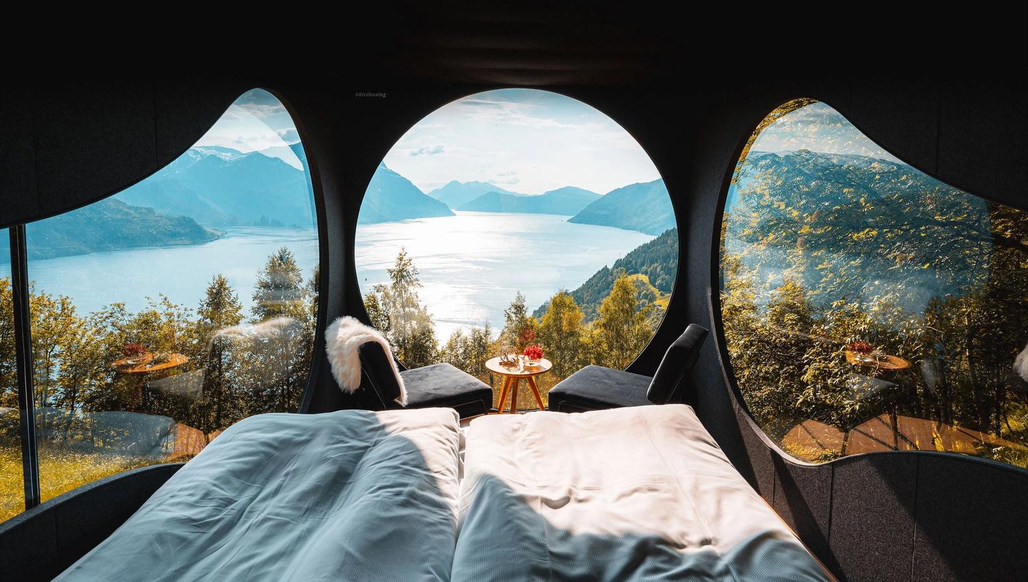Stunning panoramic view from the Birdbox cabin at Skaara Living on Lotsberg in Nordfjord, surrounded by mountains and fjord landscape.